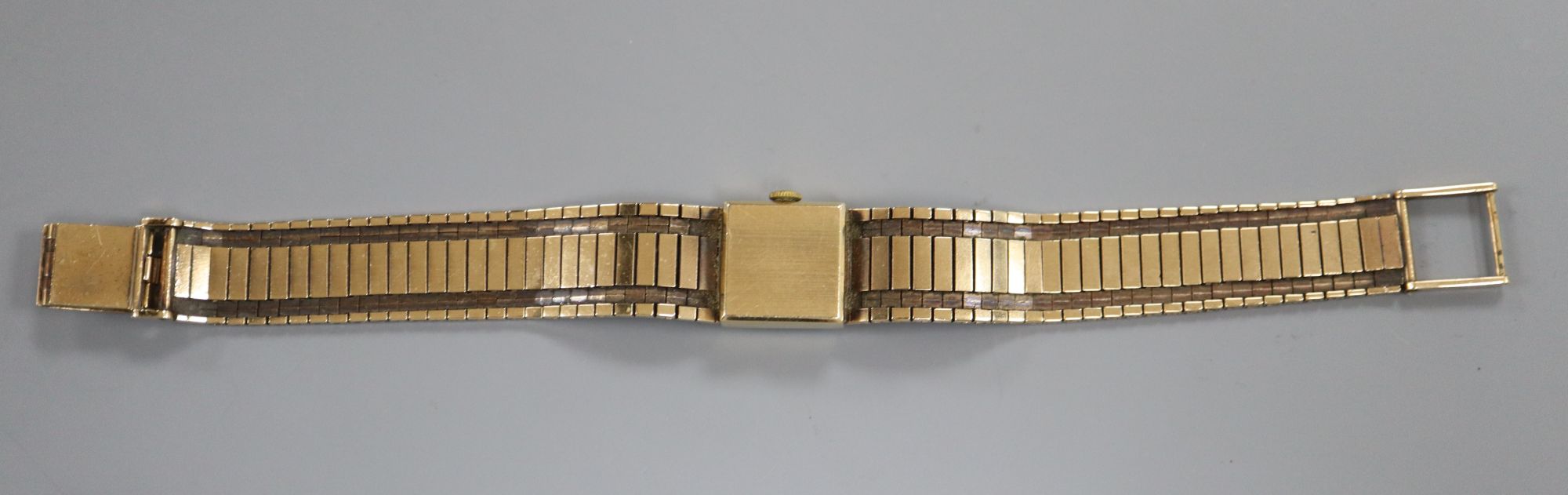 A ladys 9ct gold Rolex Precision manual wind wrist watch, on textured 9ct gold bracelet, dial and glass a.f.